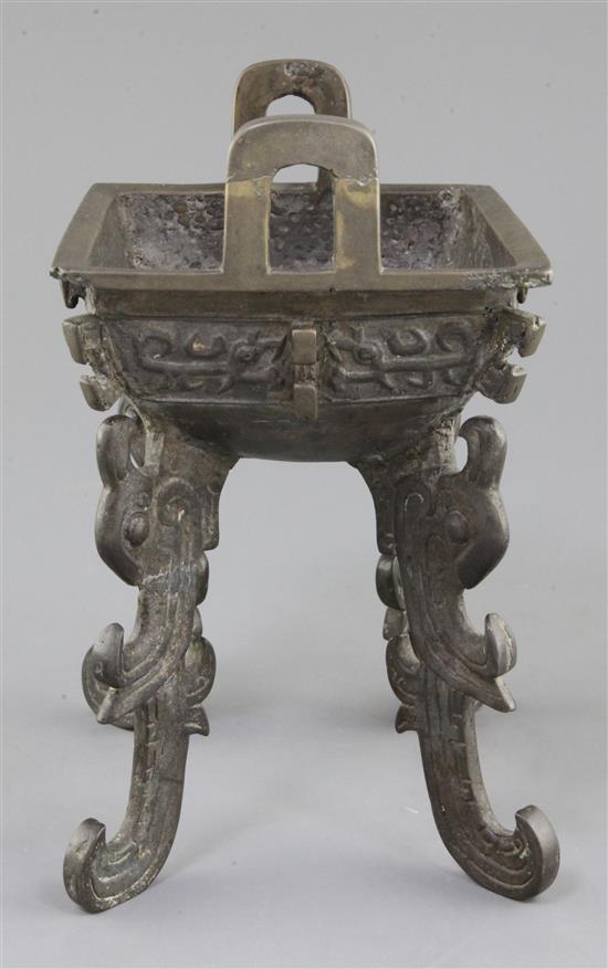 A Chinese archaic bronze quadruped ritual food vessel, Fangding, early Western Zhou dynasty, 22.7cm high, 17.5cm wide, repairs and lack